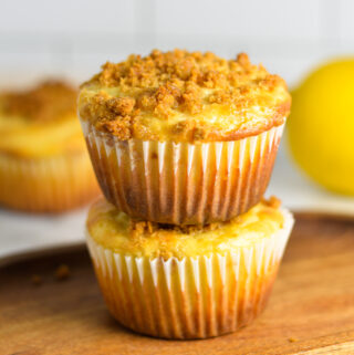 A stack of two Lemon Muffins on a wooden slab.