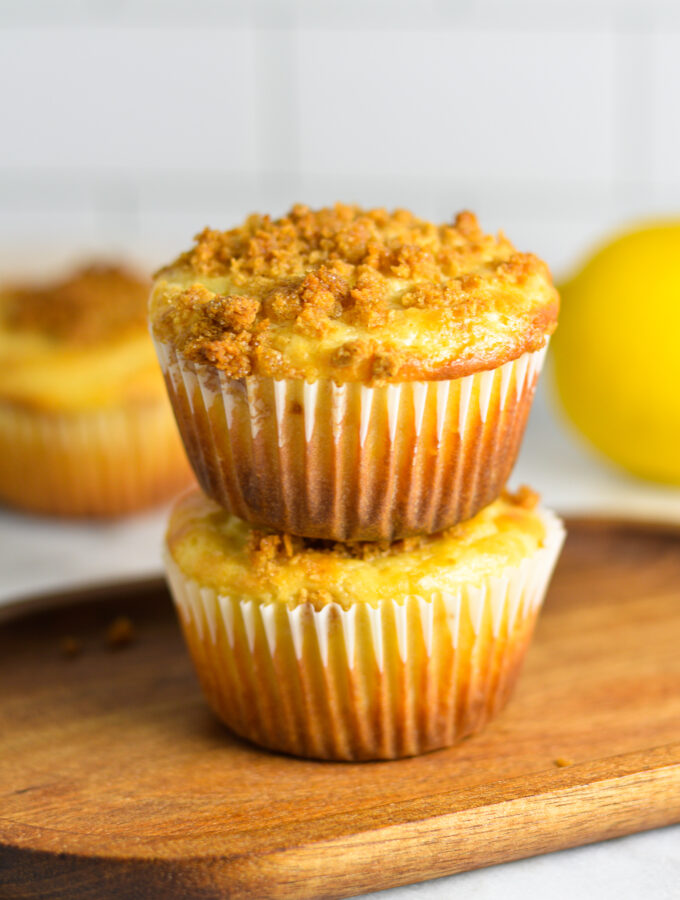 A stack of two Lemon Muffins on a wooden slab.