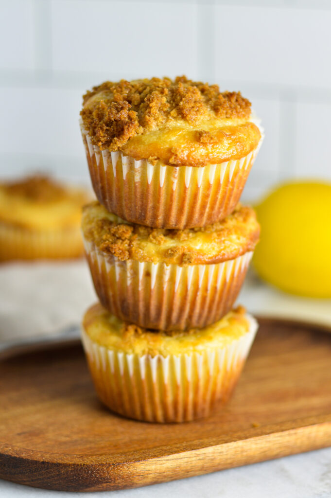 A stack of three Lemon Muffins with streusel on top.