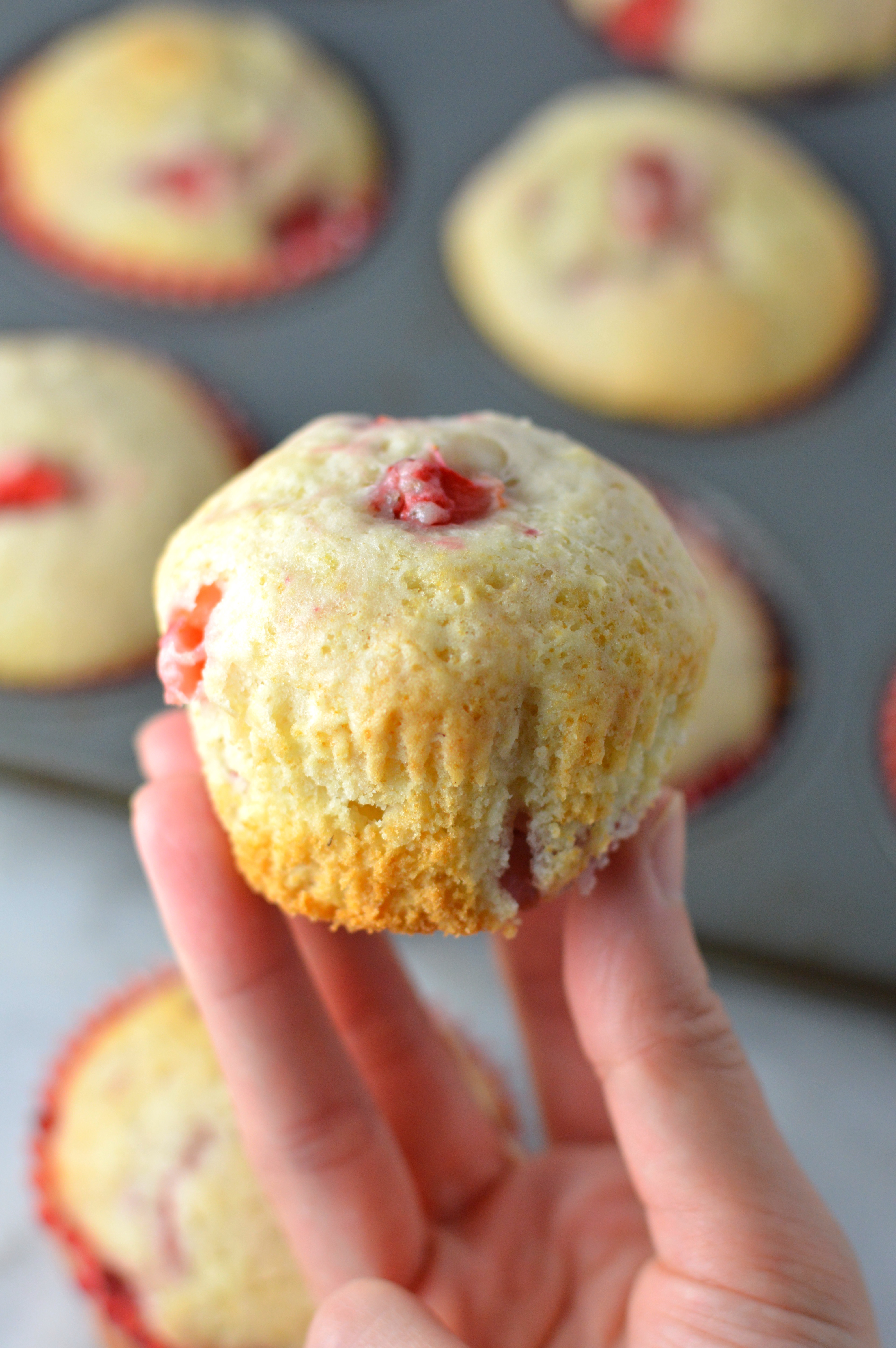 Healthy Strawberry Muffins made with olive oil. This is a great recipe to make as a nut free snack to bring to work, or a quick and easy grab and go breakfast idea.