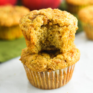 Apple muffins with a crumbly streusel topping, sprinkled with bits of cinnamon and sugar.