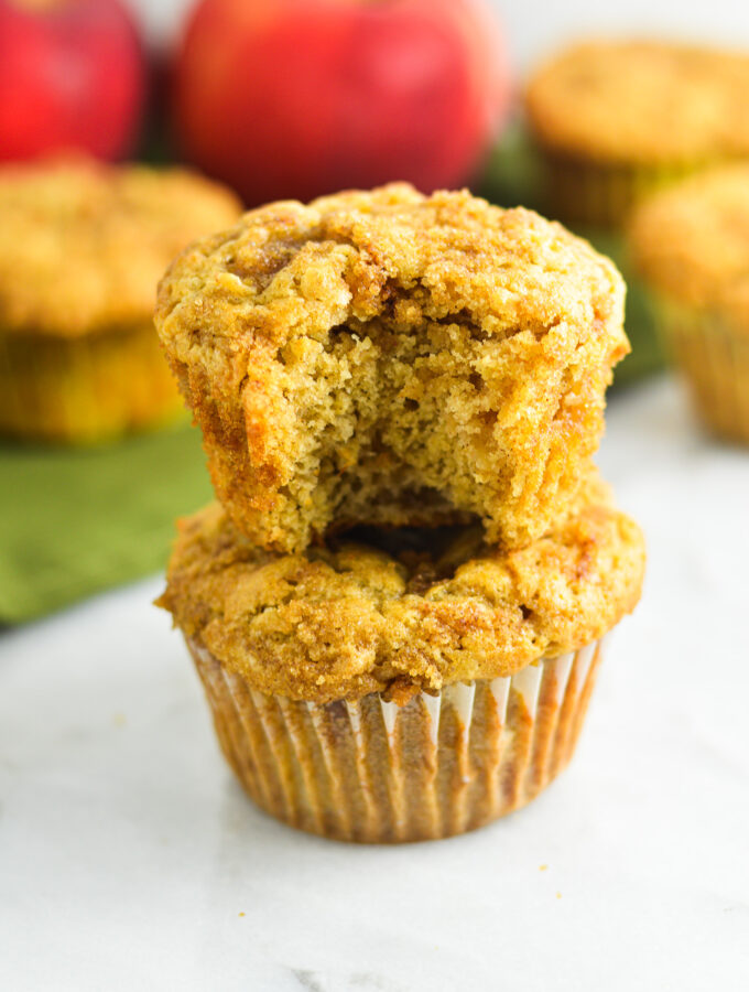 Apple muffins with a crumbly streusel topping, sprinkled with bits of cinnamon and sugar.