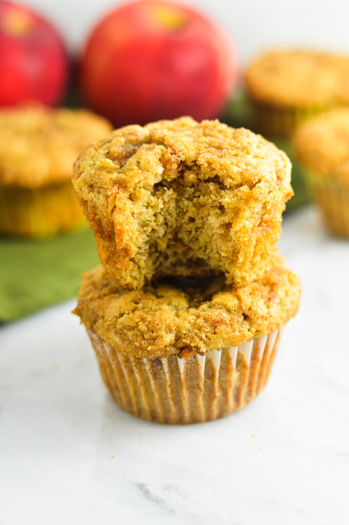 Apple muffins with a crumbly streusel topping, sprinkled with bits of cinnamon and sugar.