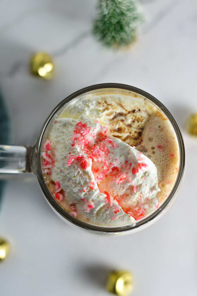 Peppermint Hot Chocolate topped with cool whip and candy cane pieces.