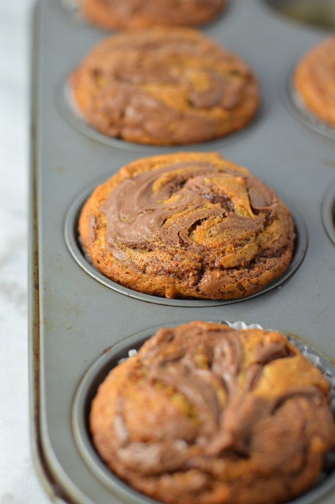 Easy Nutella Swirl Banana Muffins that are perfect for a grab and go breakfast idea. A great recipe to use up 2 ripe bananas.