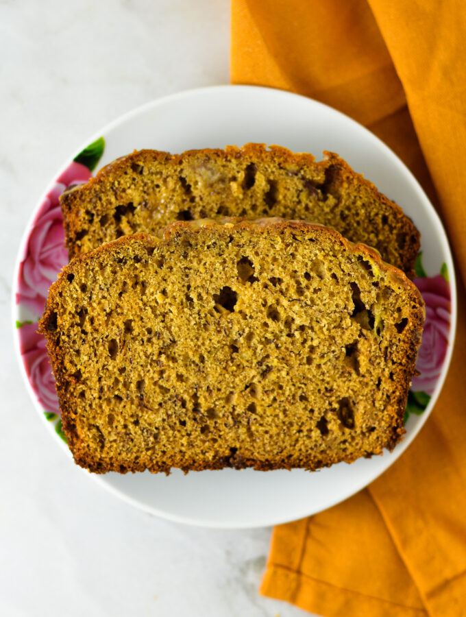 Peanut Butter Banana Bread with Peanut Butter Glaze on a small white plate.