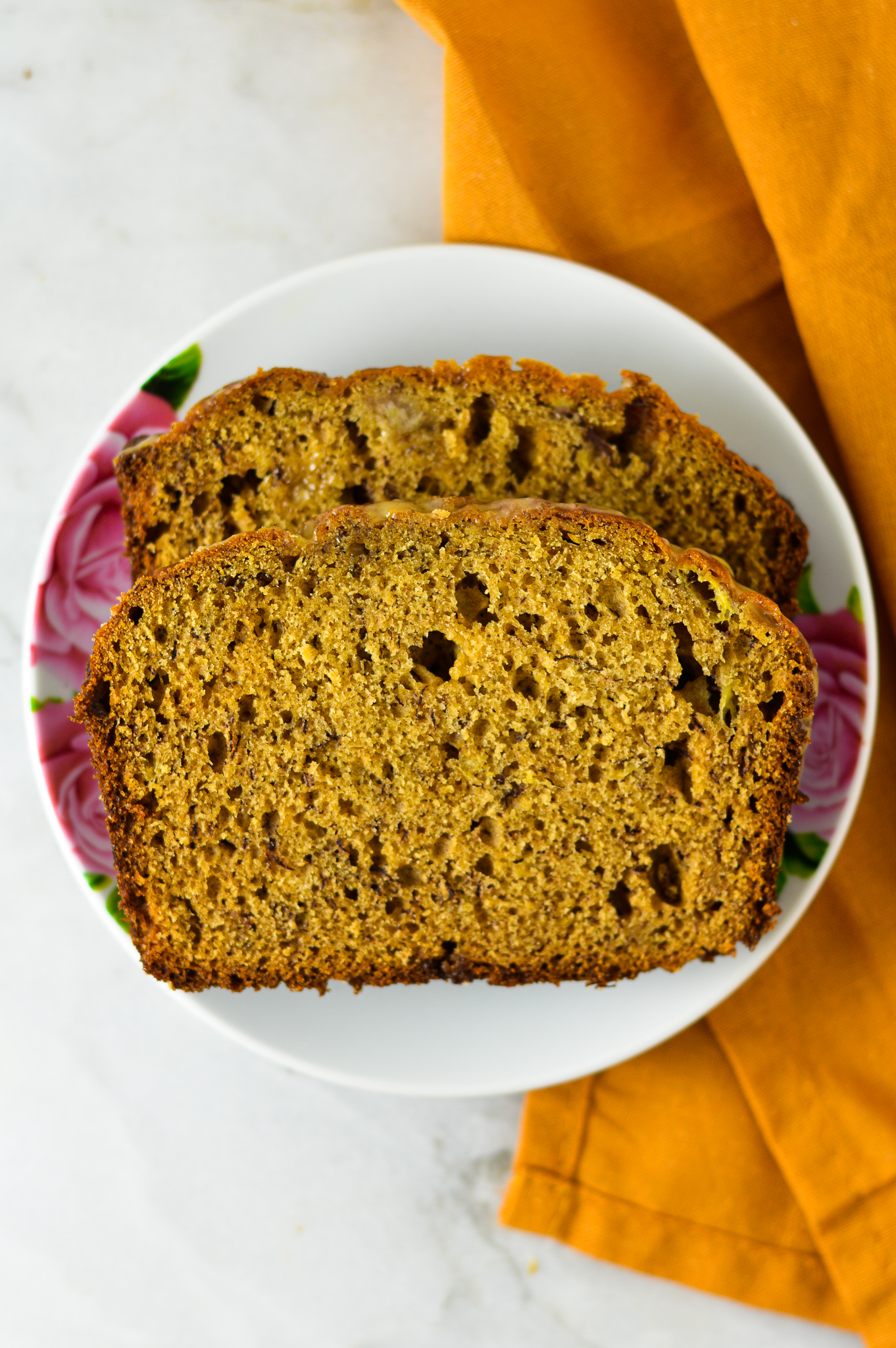 Peanut Butter Banana Bread with Peanut Butter Glaze on a small white plate.