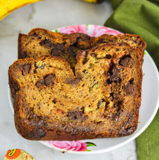 Peanut Butter Cup Banana Bread with ripe bananas and Mini Reese's peanut butter cups in the background.