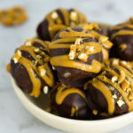 Peanut Butter Pretzel Truffles on a shallow white plate.