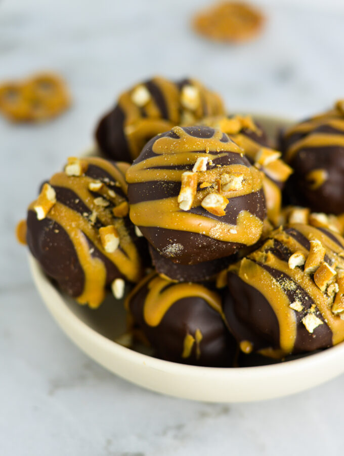 Peanut Butter Pretzel Truffles on a shallow white plate.