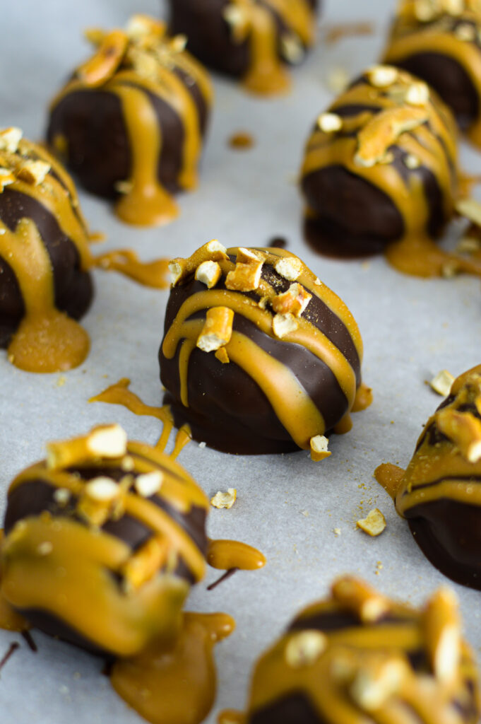 Peanut Butter Pretzel Truffles on a parchment paper lined baking sheet.