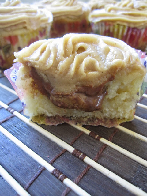 These Vanilla Bean Cupcakes with Peanut Butter Frosting are the perfect dessert recipe. Moist cupcakes with a peanut butter cup inside.