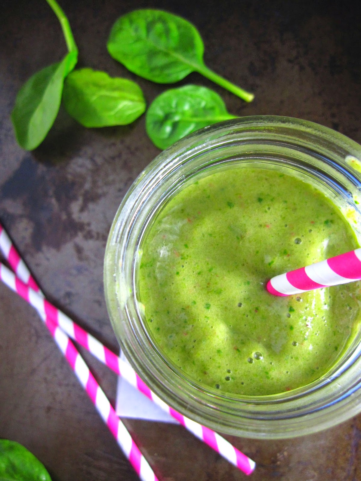 Fruity Green Smoothie made with baby spinach, peaches, mangoes, strawberries, and one banana. Such a refreshing drink.