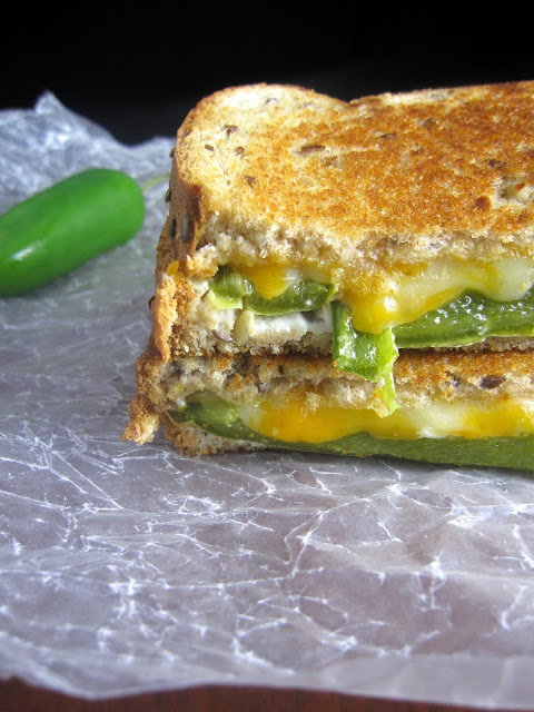 Grilled cheese sandwich with roasted jalapenos and slathered in cream cheese. The only thing missing from this jalapeno popper grilled cheese sandwich is bacon bits!