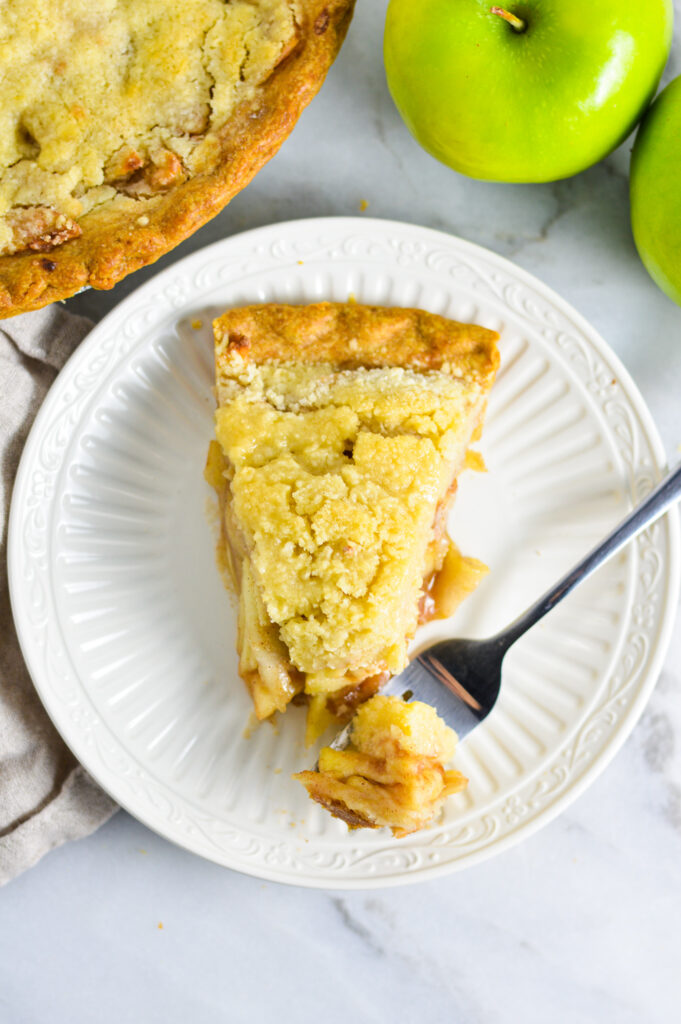 Overhead shot of Butter Crumble Apple Pie with a fork taking a piece off.