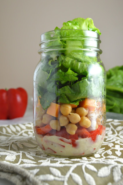 This romaine lettuce and chickpea mason jar salad is so portable and easy to make, you will want to make it for work and school every day of the week!