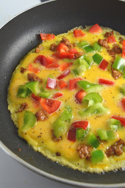 This Sausage and Bell Pepper Omelette is start to the day! With both green and red peppers, and oozing with cheese, it is guaranteed to keep you satisfied until lunch.