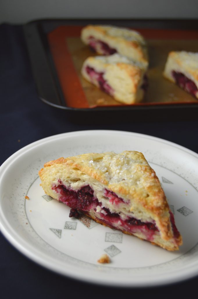 Scones bursting with raspberries in every bite. The coarse sugar topping makes them wonderfully crunchy on top.