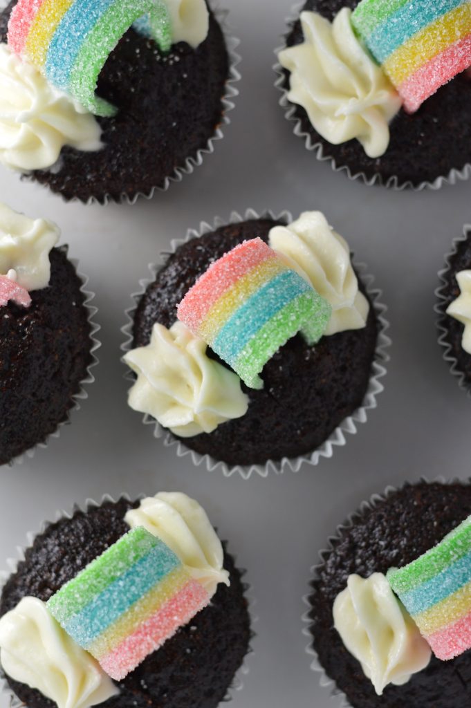 Super moist whole wheat chocolate cupcakes, with rainbows on top to make them a perfect recipe for St.Patrick’s Day