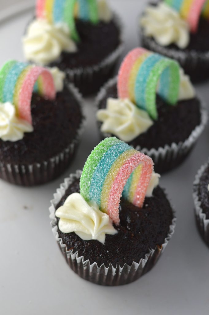 Super moist whole wheat chocolate cupcakes, with rainbows on top to make them a perfect recipe for St.Patrick’s Day