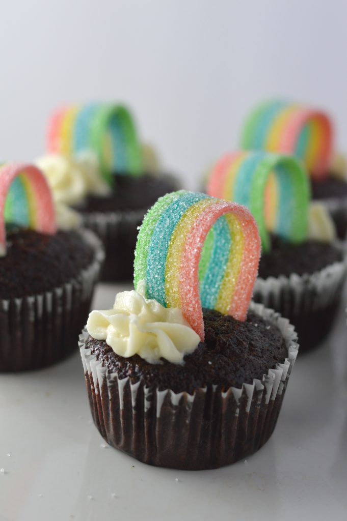 Super moist whole wheat chocolate cupcakes, with rainbows on top to make them a perfect recipe for St.Patrick’s Day