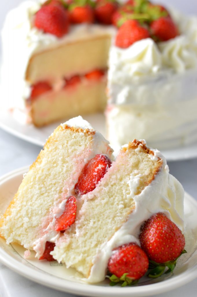 Easy strawberry layer cake recipe made from scratch! White cake with buttercream frosting, this is perfect for Canada Day, Valentine's Day or any other special occasion.