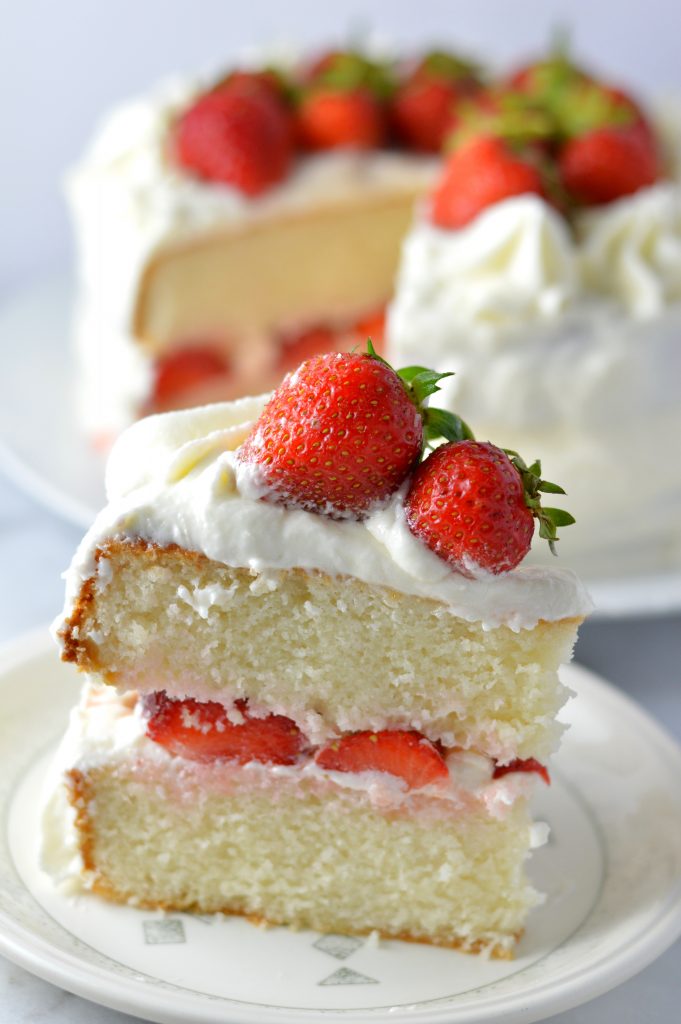 Easy strawberry layer cake recipe made from scratch! White cake with buttercream frosting, this is perfect for Canada Day, Valentine's Day or any other special occasion.