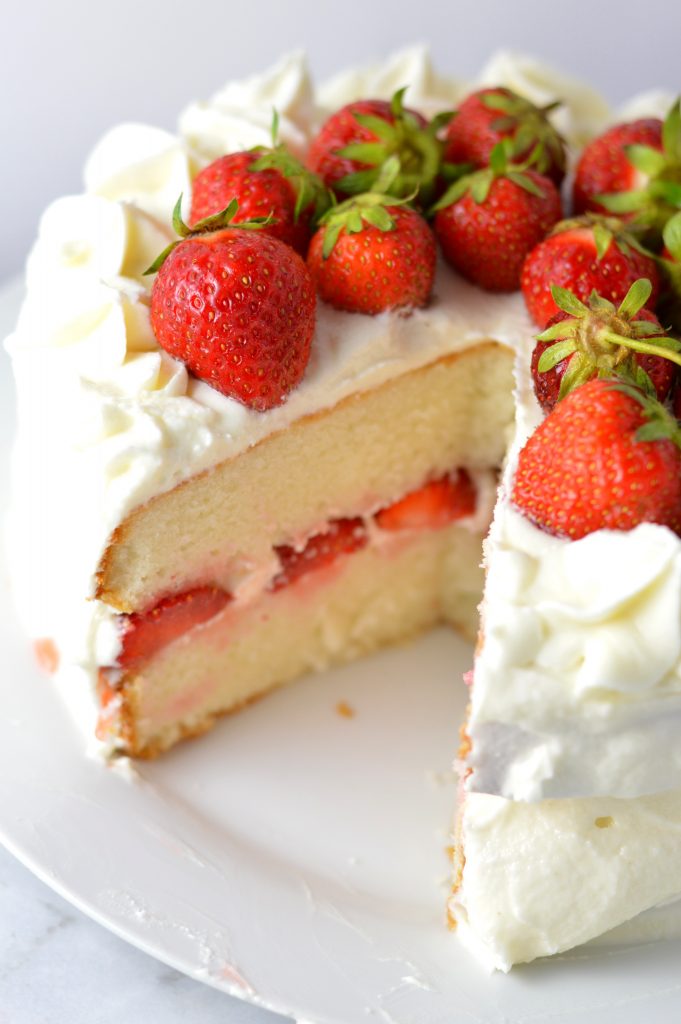 Easy strawberry layer cake recipe made from scratch! White cake with buttercream frosting, this is perfect for Canada Day, Valentine's Day or any other special occasion.