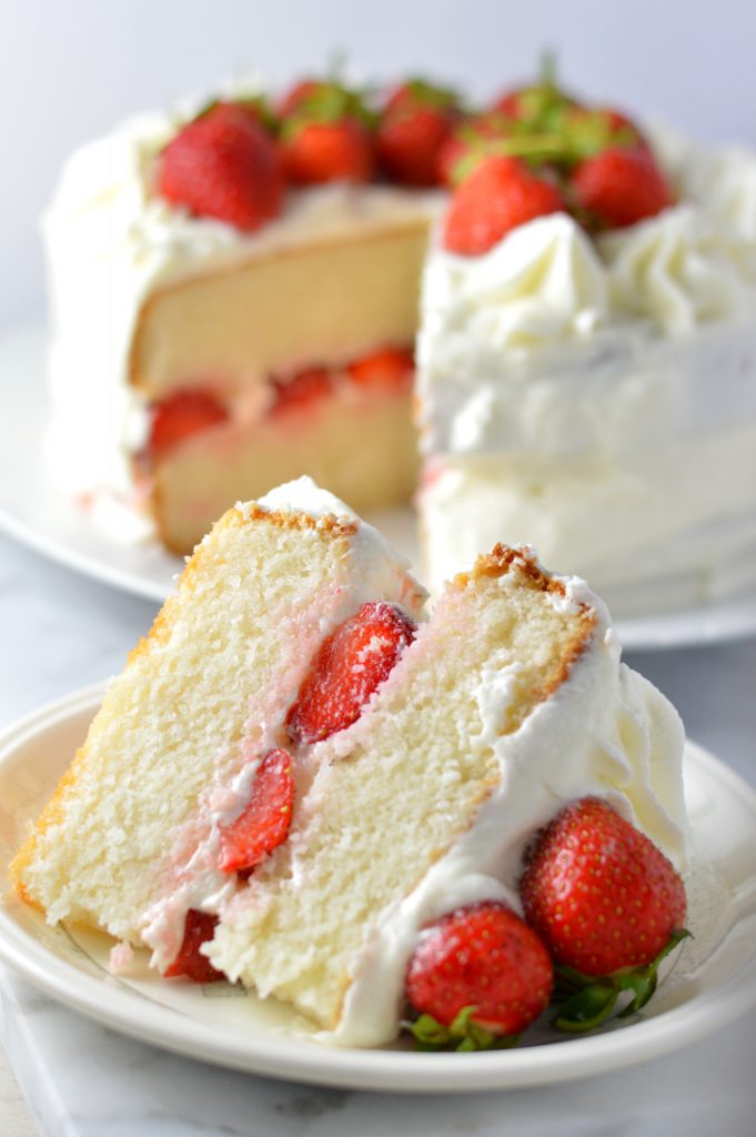 Easy strawberry layer cake recipe made from scratch! White cake with buttercream frosting, this is perfect for Canada Day, Valentine's Day or any other special occasion.