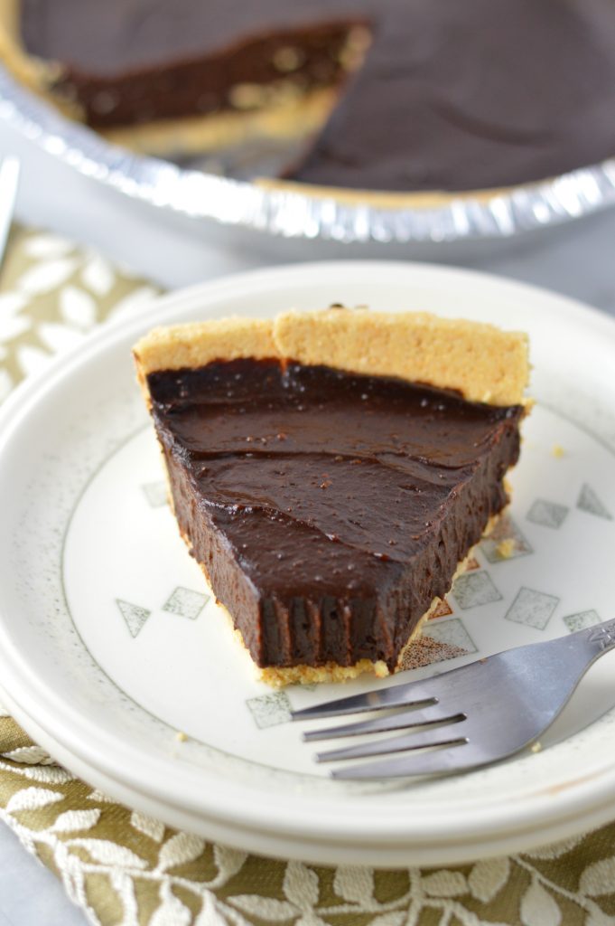 Vegan Chocolate, Peanut Butter and Avocado Pie recipe that is gluten free and so quick and easy to make. Rich and fudgy dessert idea.