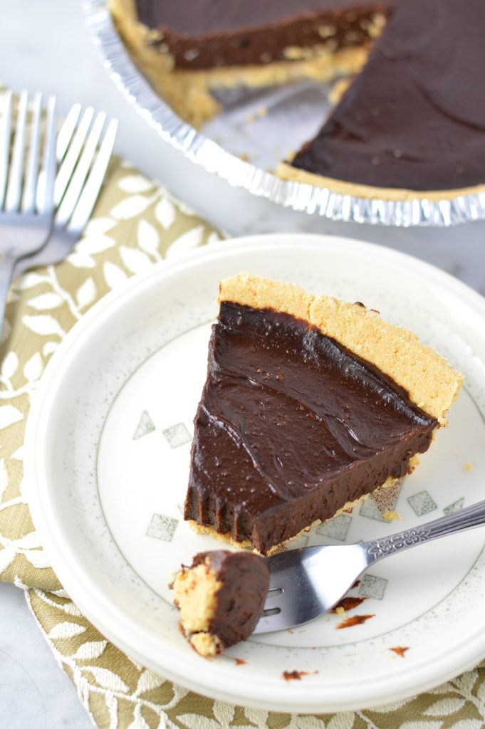 Vegan Chocolate, Peanut Butter and Avocado Pie recipe that is gluten free and so quick and easy to make. Rich and fudgy dessert idea.