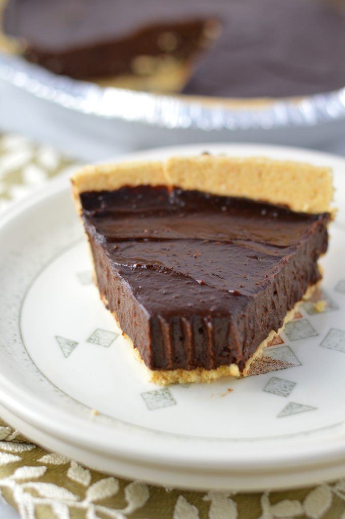 Vegan Chocolate, Peanut Butter and Avocado Pie recipe that is gluten free and so quick and easy to make. Rich and fudgy dessert idea.