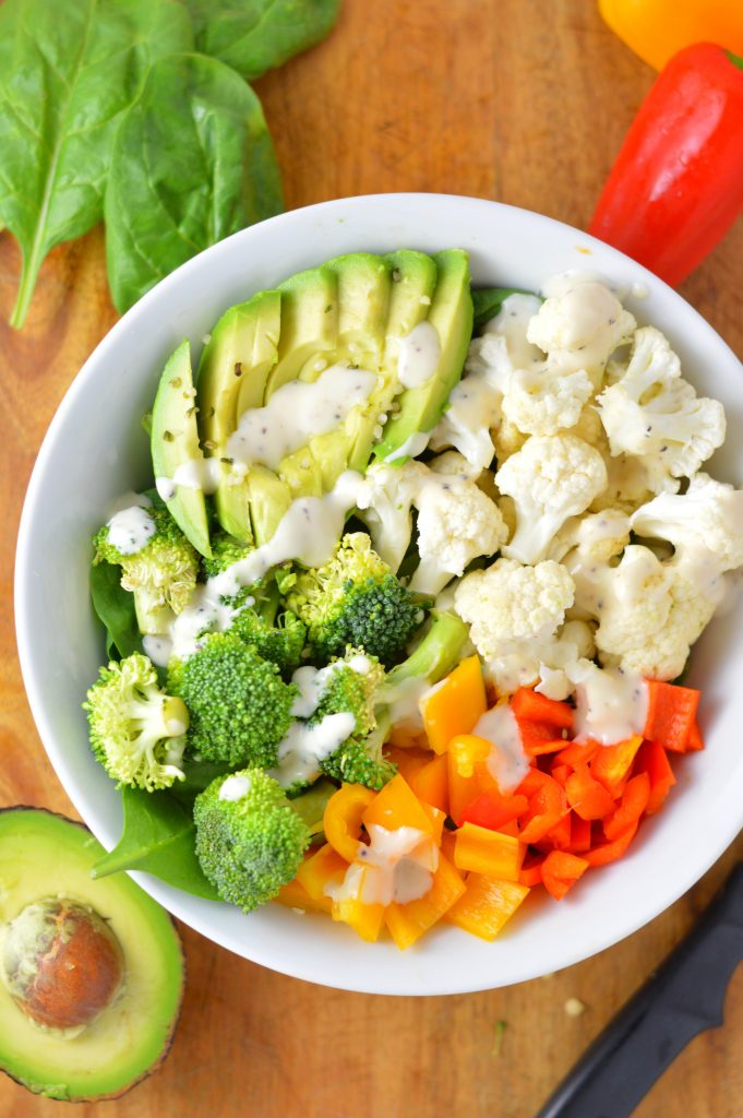 Super simple Veggie Buddha Bowl made with spinach, cauliflower, broccoli, bell peppers and, of course, avocado. Perfect for lunch or dinner.