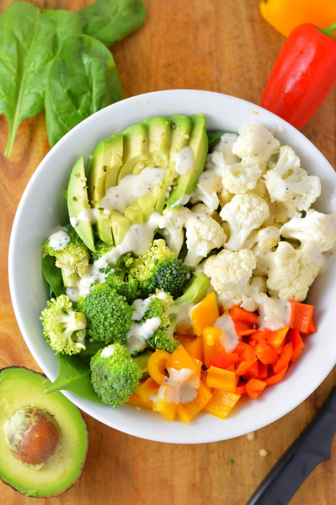 Super simple Veggie Buddha Bowl made with spinach, cauliflower, broccoli, bell peppers and, of course, avocado. Perfect for lunch or dinner.