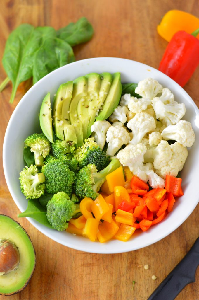 Super simple Veggie Buddha Bowl made with spinach, cauliflower, broccoli, bell peppers and, of course, avocado. Perfect for lunch or dinner.