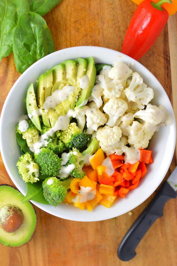 Super simple Veggie Buddha Bowl made with spinach, cauliflower, broccoli, bell peppers and, of course, avocado. Perfect for lunch or dinner.