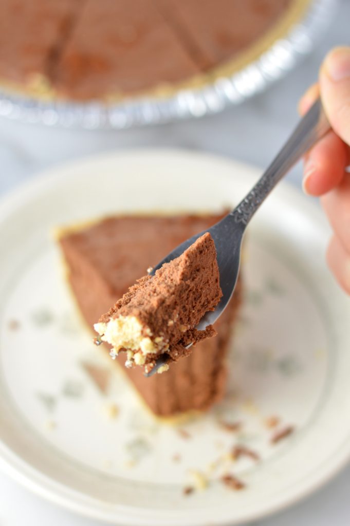 Rich No Bake Chocolate Truffle Pie is the perfect dessert recipe for a holiday party or to enjoy at home. Made with a graham cracker crust.