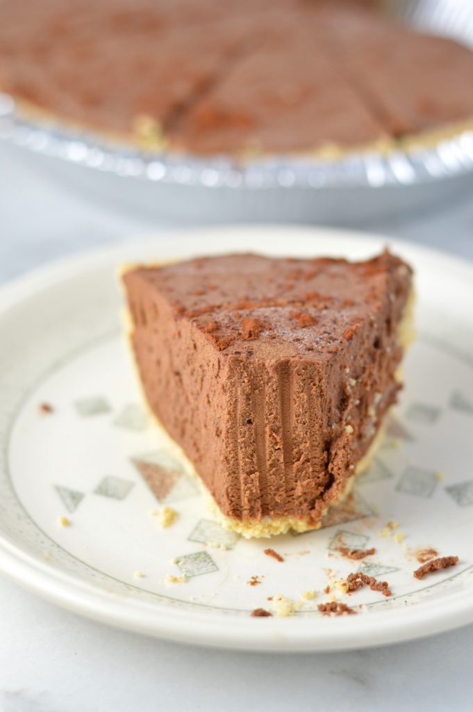 Rich No Bake Chocolate Truffle Pie is the perfect dessert recipe for a holiday party or to enjoy at home. Made with a graham cracker crust.