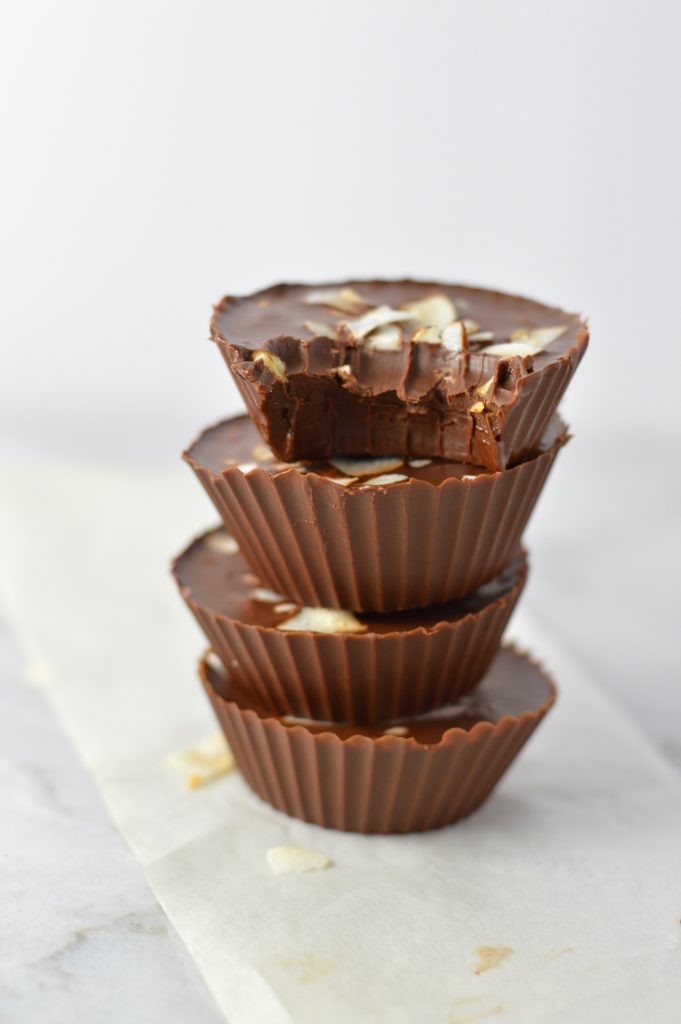 3 Ingredient Chocolate Peanut Butter Coconut Cups recipe makes for a quick and easy dessert idea. Made with coconut oil and topped with coconut chips,