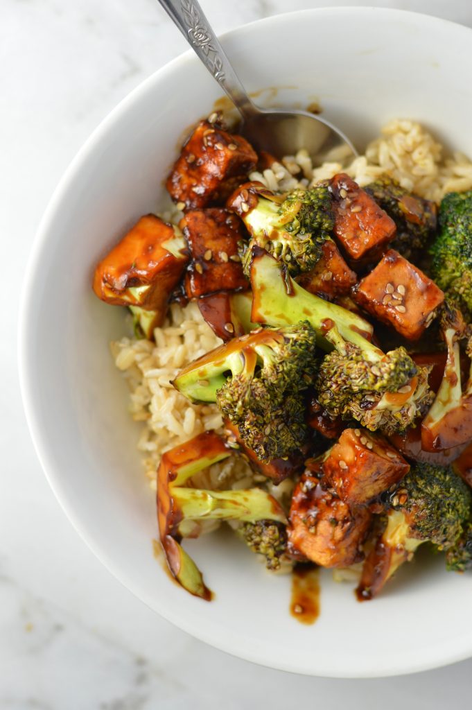 Overhead shot of pan-fried Tofu Sesame Broccoli Stir Fry in a white bowl.