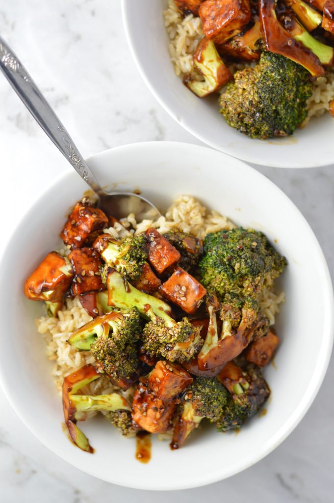 Overhead view of some Tofu Sesame Broccoli Stir Fry on brown rice in a bowl.