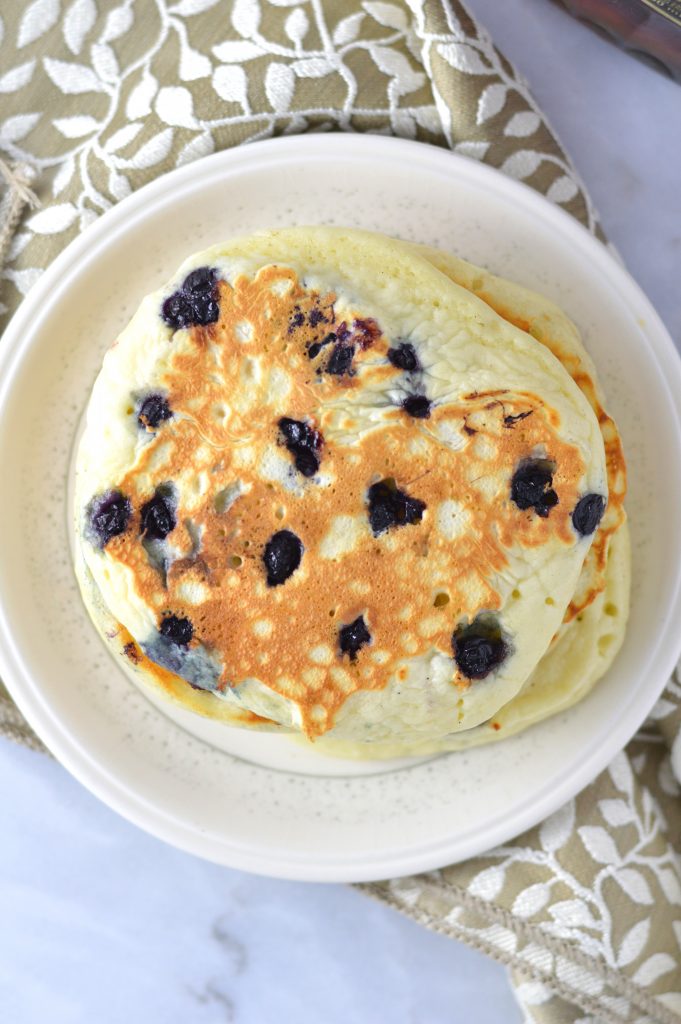 Fluffy Blueberry Pancakes recipe made with fresh blueberries. So easy to make, and somewhat healthy, they make a delicious filling breakfast idea.