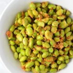 Healthy Roasted Parmesan Edamame recipe.Frozen edamame is baked in the oven to make a quick and easy appetizer or snack idea.