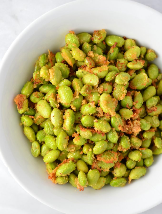 Healthy Roasted Parmesan Edamame recipe.Frozen edamame is baked in the oven to make a quick and easy appetizer or snack idea.