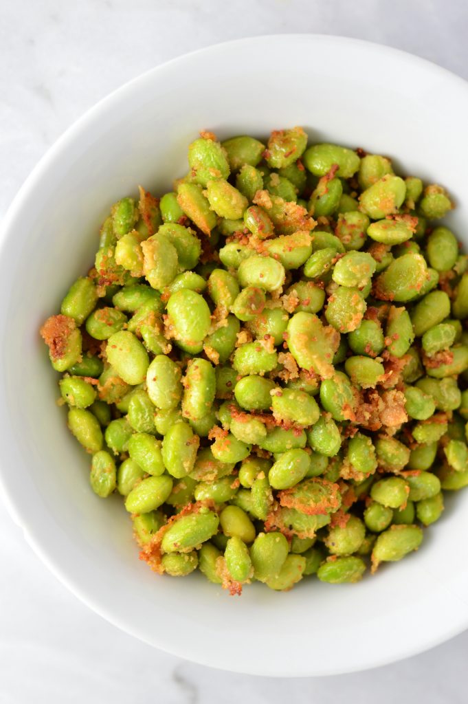 Healthy Roasted Parmesan Edamame recipe.Frozen edamame is baked in the oven to make a quick and easy appetizer or snack idea.