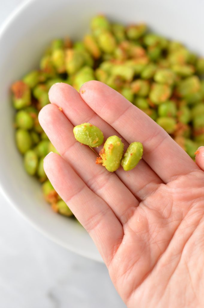 Healthy Roasted Parmesan Edamame recipe.Frozen edamame is baked in the oven to make a quick and easy appetizer or snack idea.