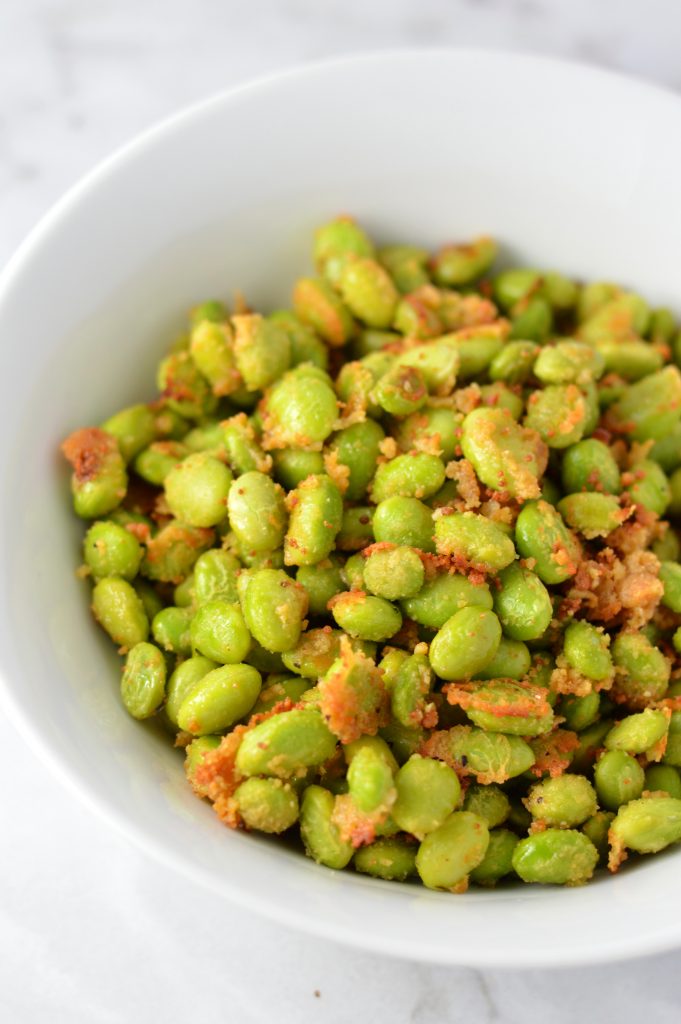 Healthy Roasted Parmesan Edamame recipe.Frozen edamame is baked in the oven to make a quick and easy appetizer or snack idea.