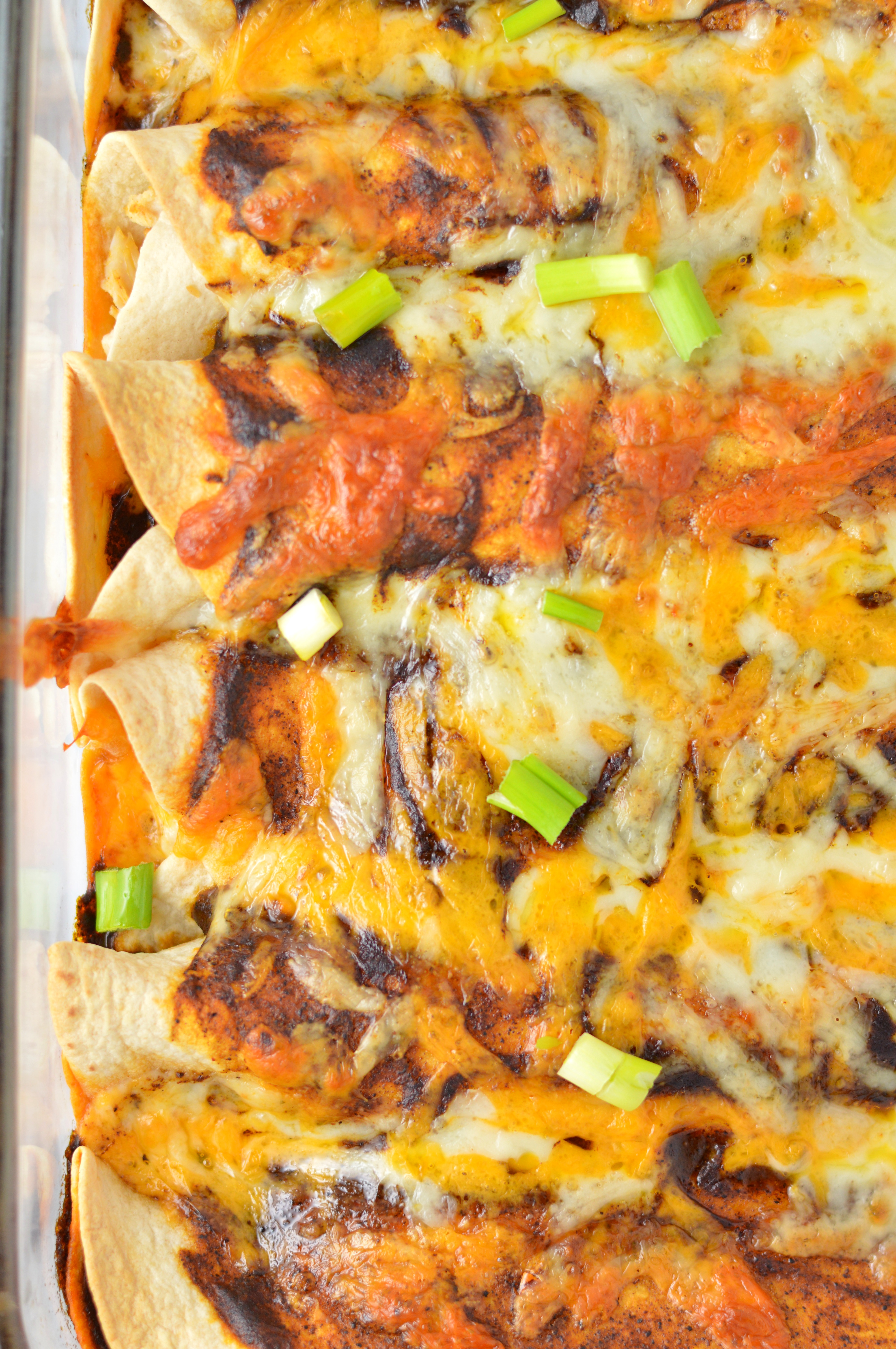 Easy spicy Chicken Enchiladas recipe with homemade enchilada sauce. The ultimate comfort food, it's a great dinner idea to use up your leftover chicken