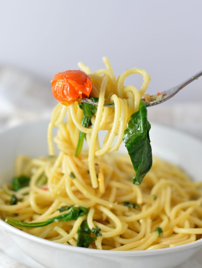 Healthy Spinach and Cherry Tomato Spaghetti. This pasta recipe is vegan and ready in under 30 minutes. Perfect for a quick and easy weeknight dinner idea.