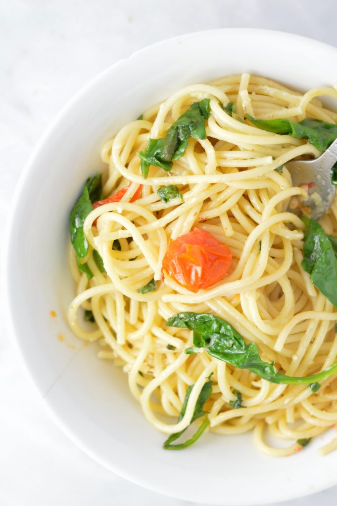 Healthy Spinach and Cherry Tomato Spaghetti. This pasta recipe is vegan and ready in under 30 minutes. Perfect for a quick and easy weeknight dinner idea.